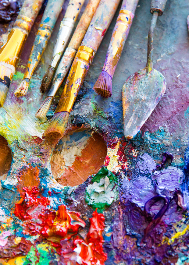 Paint brushes and palette knife on a painting palette