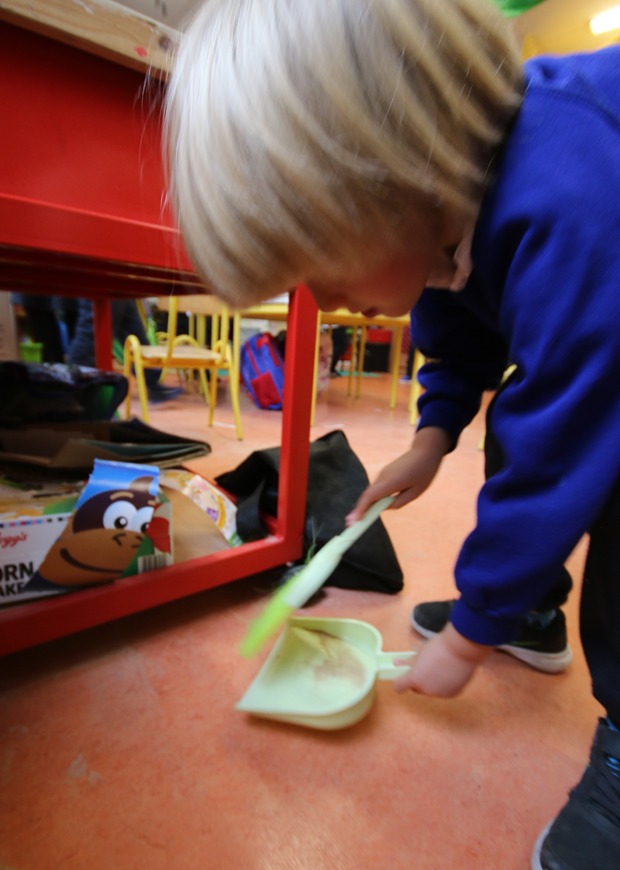 Child in classroom cleaning