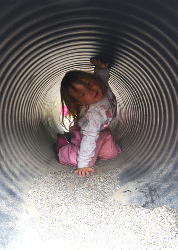 Child in a tube outdoors, portrait format