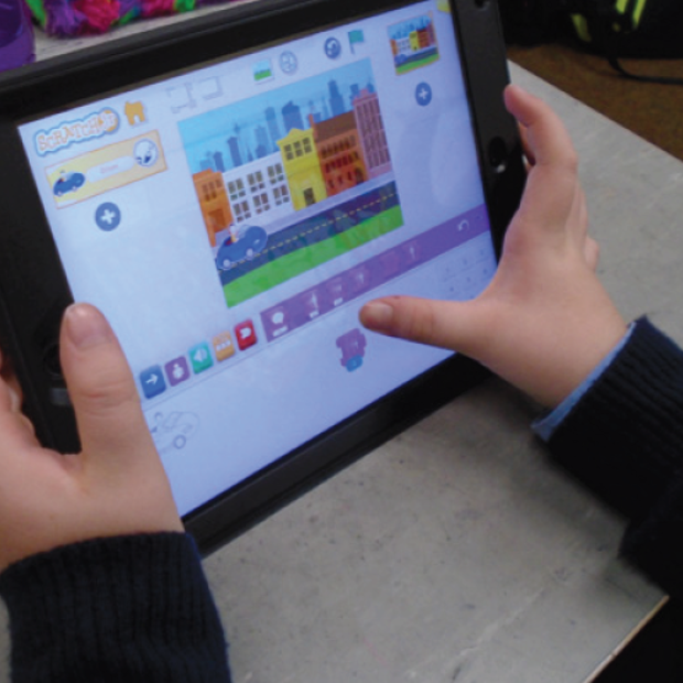 Child using Scratch on tablet device