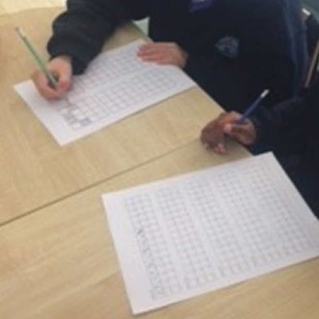 Children writing on graph paper