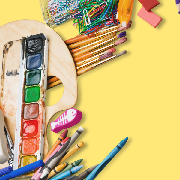 Various art materials on a yellow desk