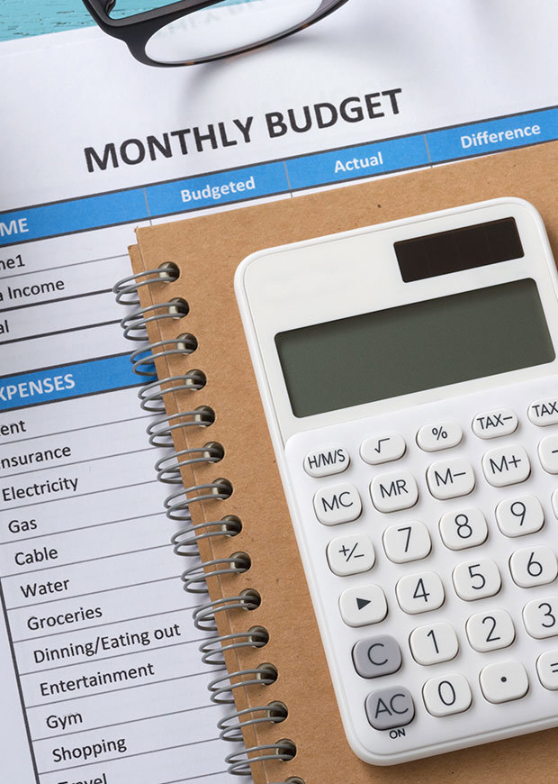 Calculator and monthly budget form, portrait crop