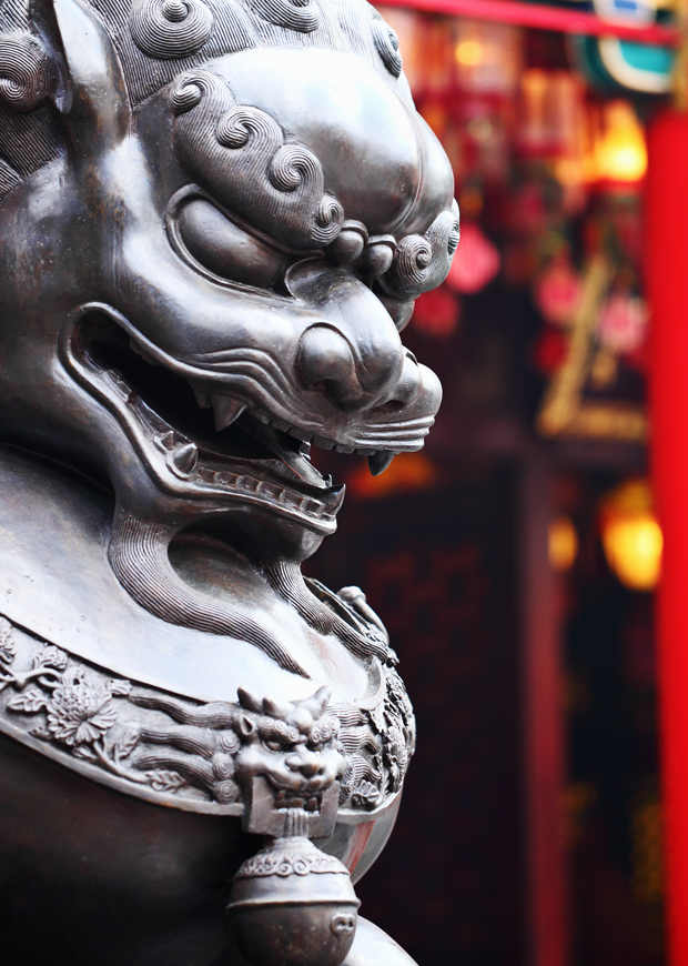 Close up image of Chinese lion in front of a temple