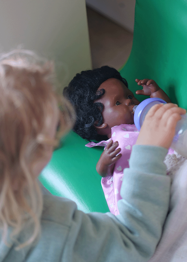 Child playing with a doll